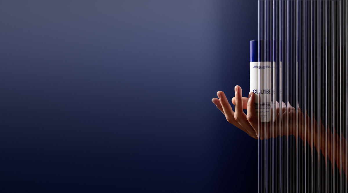 CULISE hair oil held behind fluted glass