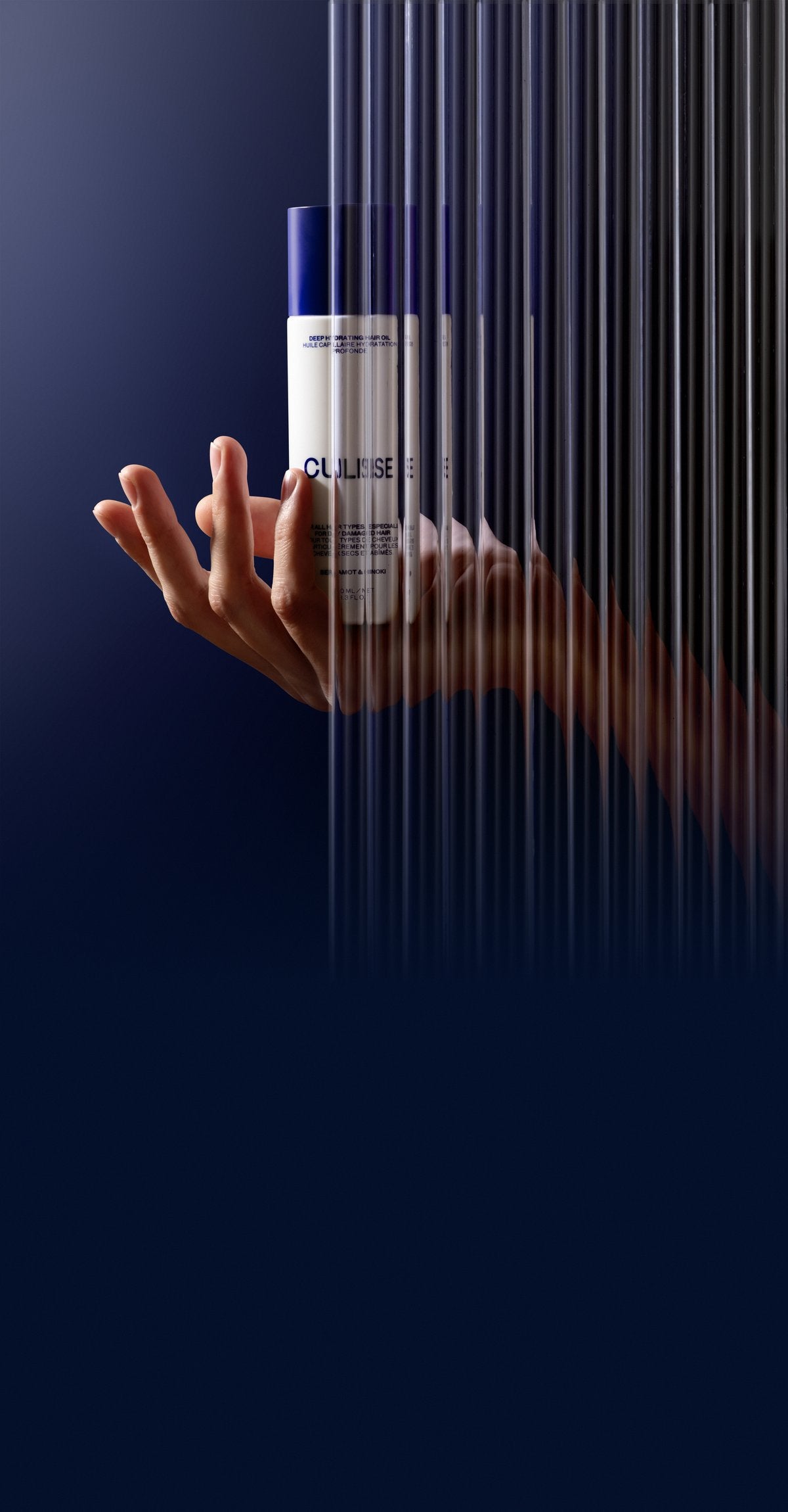 CULISE hair oil held behind fluted glass