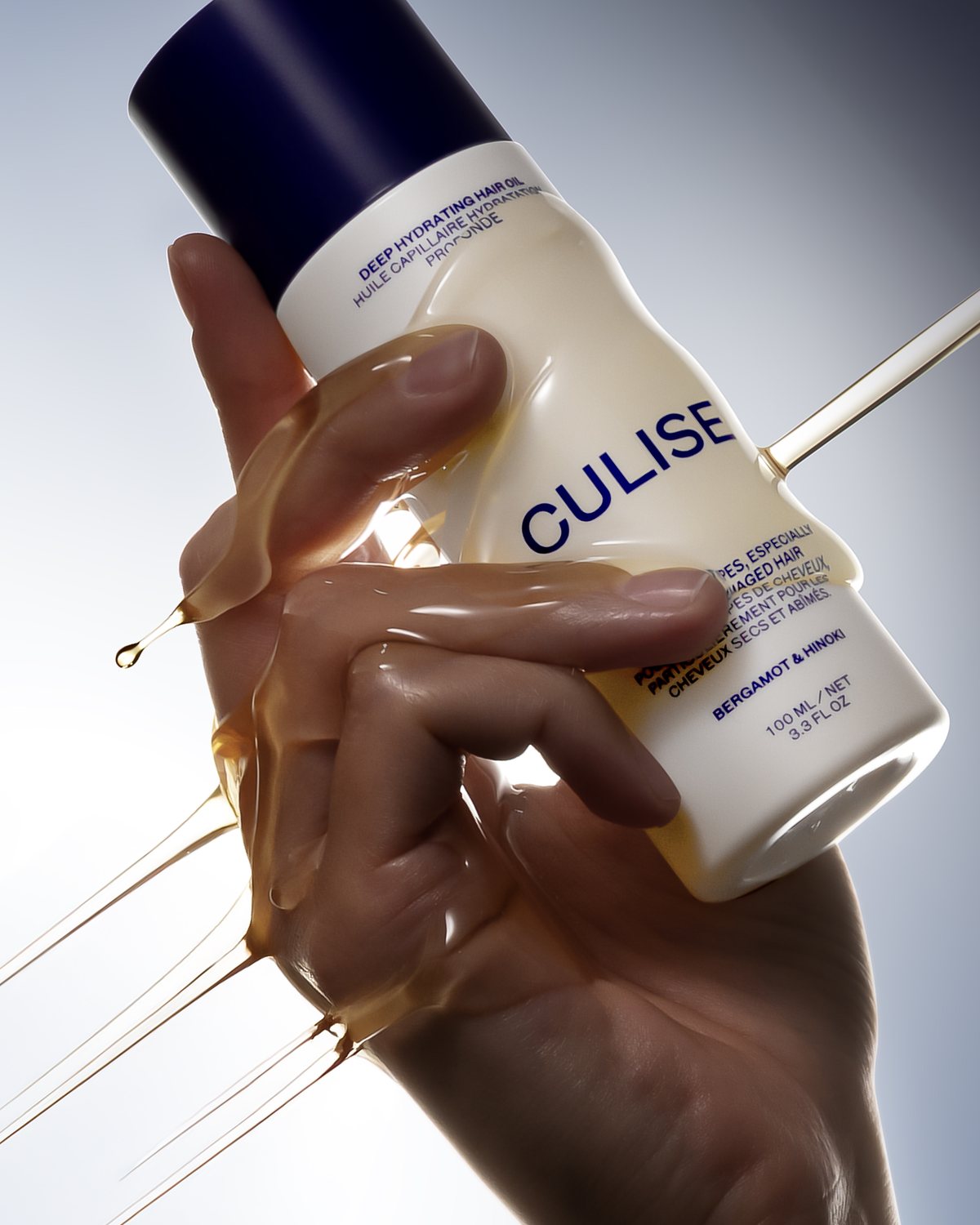 CULISE Deep Hydrating Hair Oil pouring over a hand