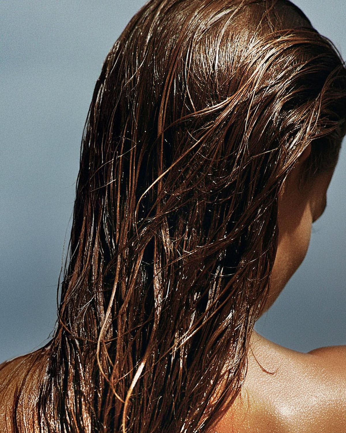 Woman with long wet hair from behind